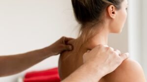 Closeup of masseur man's hands during back massage for young wom